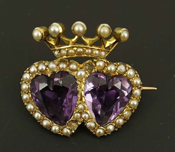 A late Victorian 9ct gold, two stone heart shaped amethyst and seed pearl cluster set coronet brooch